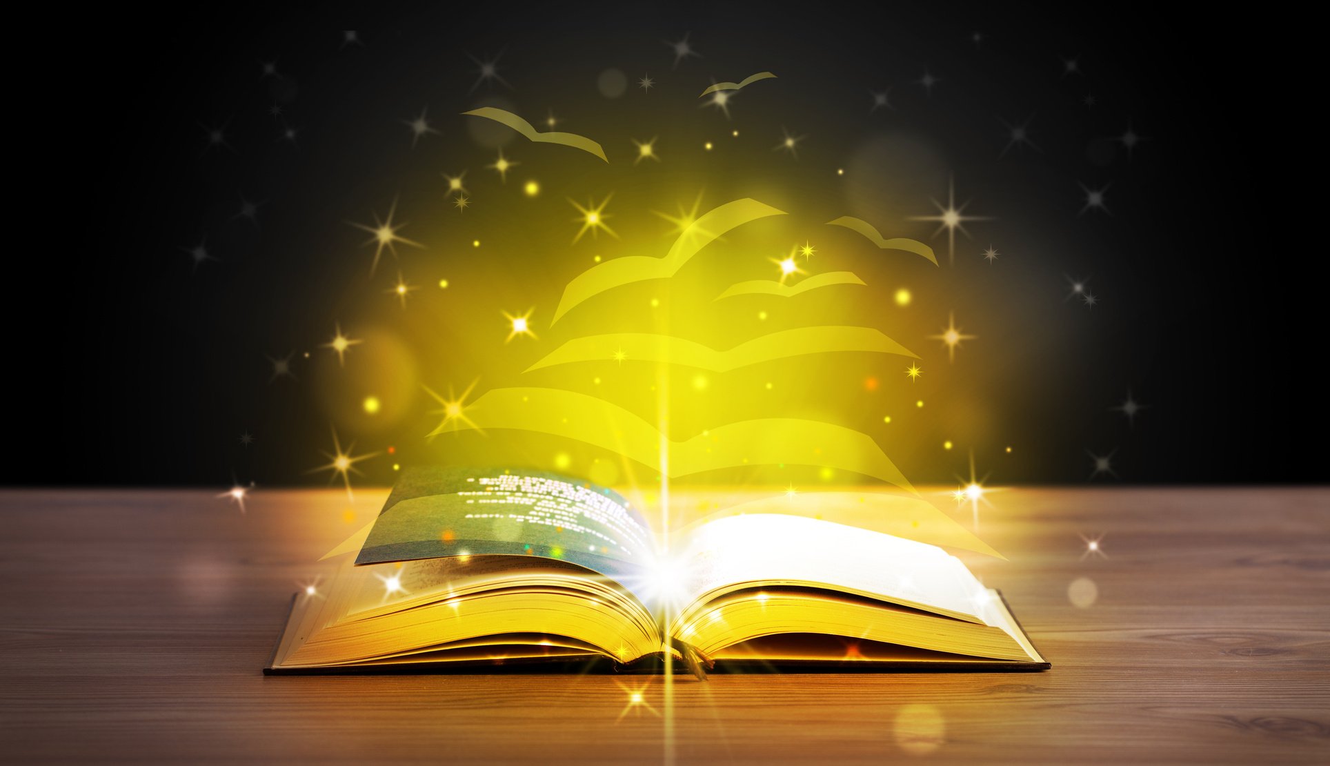 Open book with golden glow flying paper pages